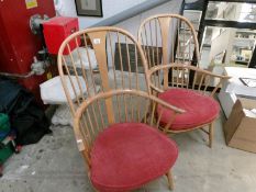 A pair of Ercol stick back armchairs