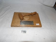 A presentation gavel with silver plaque