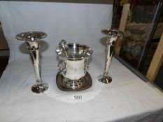 A silver plated ice bucket with tongs and a pair of silver plated vases