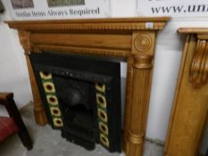 A Victorian style cast iron fire place with art nouveau decoration and surround
