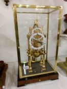 A cased brass skeleton clock