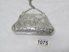A heavily embosses silver purse, Birmingham 1918/19, maker N I M,