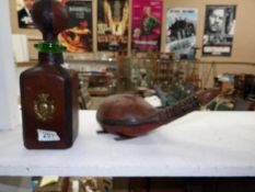An Italian leather bound flask in the shape of a tortoise and a leather bound bottle