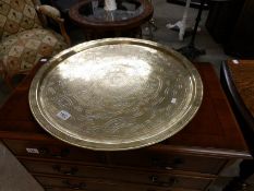 A large brass circular tray