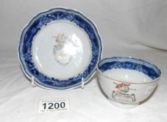 A monogrammed tea bowl and saucer