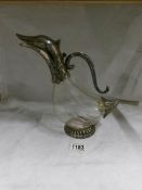 An early 20th century glass claret jug with silver plated spout in the form of a duck's head
