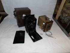 A leather cased Zeiss Ikon camera and a Kodak Brownie camera