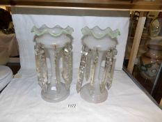 A pair of opaque glass lustres