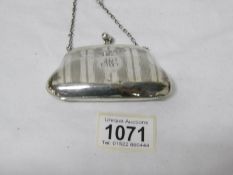 A small silver purse, Birmingham 1912/13, maker J W & S, (some dints),