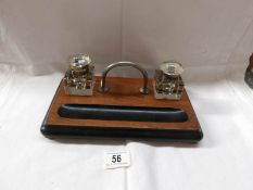 A Victorian ink stand with glass inkwells