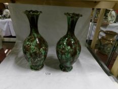 A pair of green pottery vases,