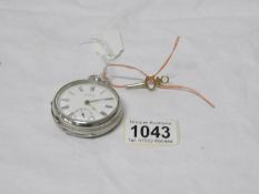 A Waltham silver pocket watch with key