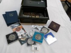 A tin box of mixed coins