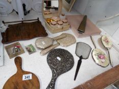 A mixed lot including silver and deco mirrors, brushes,