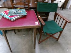 A folding card table with leather top and a director's chair