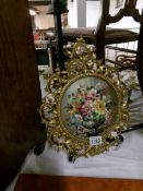 A gilt framed floral picture