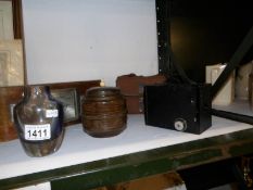 A thermometer/barometer, box brownie camera,