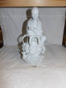 A late 17th early 18th century white glazed Chinese figure, marked and signed,