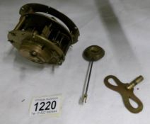 A Victorian clock movement with pendelum and key