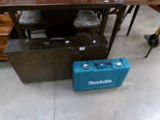 An old tool box with contents and a Makita cordless drill