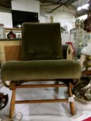 A green upholstered child's rocking chair