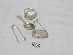 A silver port decanter label, Birmingham 1976, A silver spoon London 1844/45, A Napkin ring,