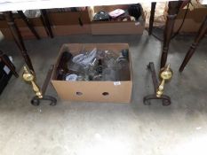 A pair of Victorian brass and iron firedogs and a quantity of glass bottles