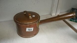 A lidded copper pan