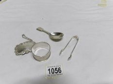 A silver caddy spoon, silver sugar tongs,