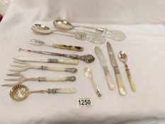 A quantity of plated cutlery including salad servers etc
