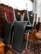 A set of 4 black and chrome dining chairs