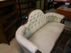 A Victorian ebonised wood framed sofa