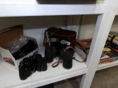 A cased pair of Yashica binoculars and a pair of Prinz binoculars