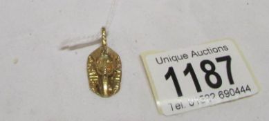 A 9ct gold Tut-ank-amen death mask pendant,