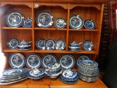 Approximately 60 piece of blue and white willow pattern dinnerware including dinner plates,