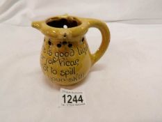 A glazed terracotta puzzle jug