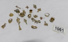 A mixed lot of yellow metal charms including some gold