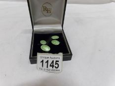 A pair of silver and enamel cuff links