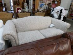 A floral Chesterfield style sofa