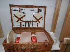 A wicker picnic basket with contents