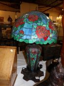 A large table lamp with Tiffany style base and shade