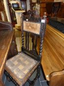 An 18th century oak carved chair with barley twist supports