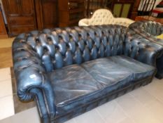 A blue leather Chesterfield sofa