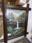 A framed and glazed waterfall scene