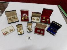 A quantity of cased cuff links