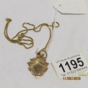 A 9ct gold fob and chain