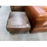 A brown leather stool