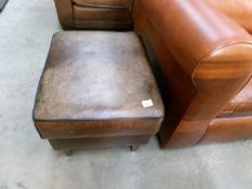 A brown leather stool