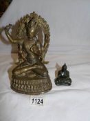 A brass Ganesha figure and a green jade Buddha