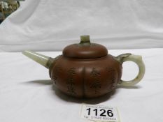 A Chinese Yixing pottery teapot with jade handle,